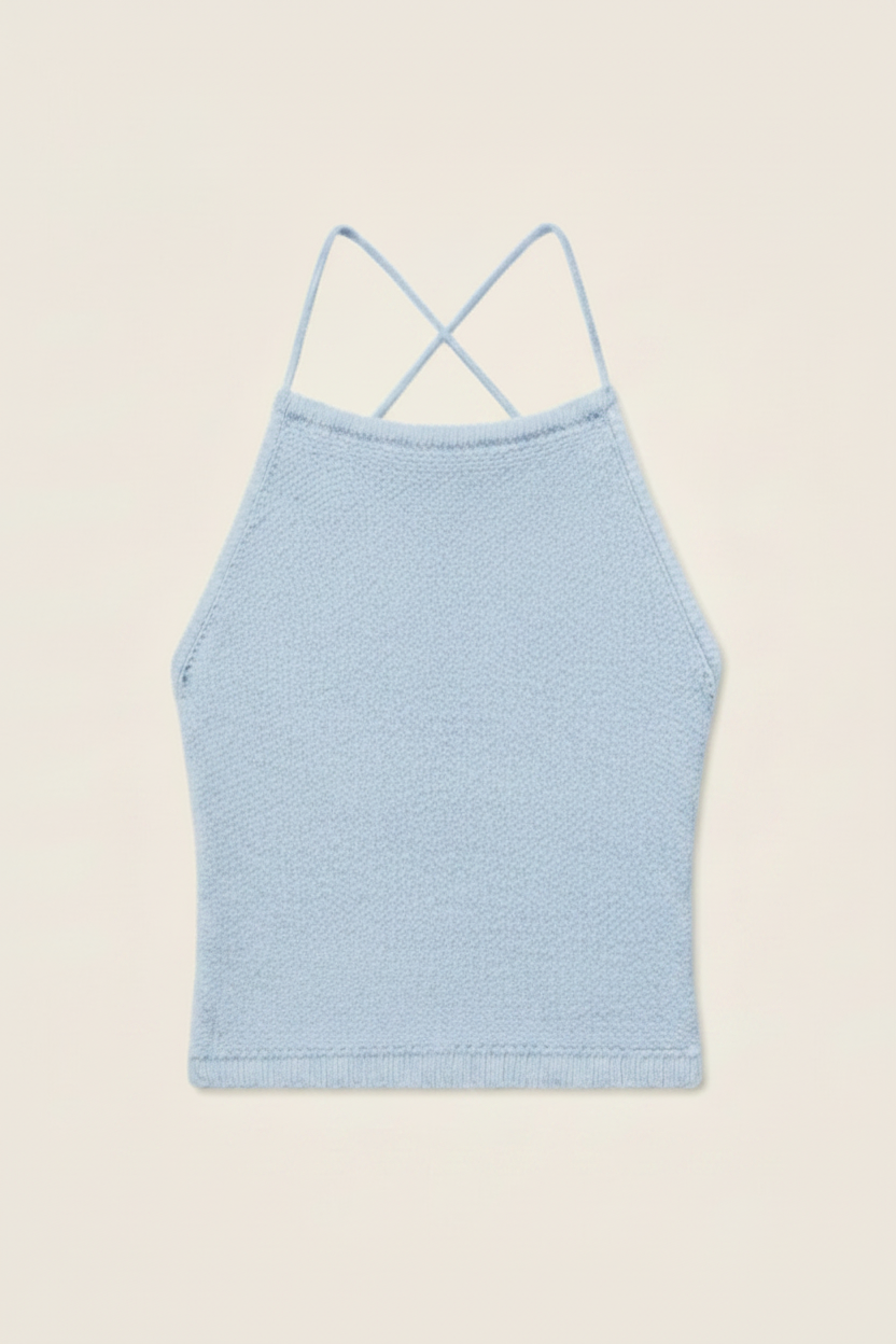 A pale blue
 knit camisole top with thin double spaghetti straps that cross at the back, shown flat against a light cream background.