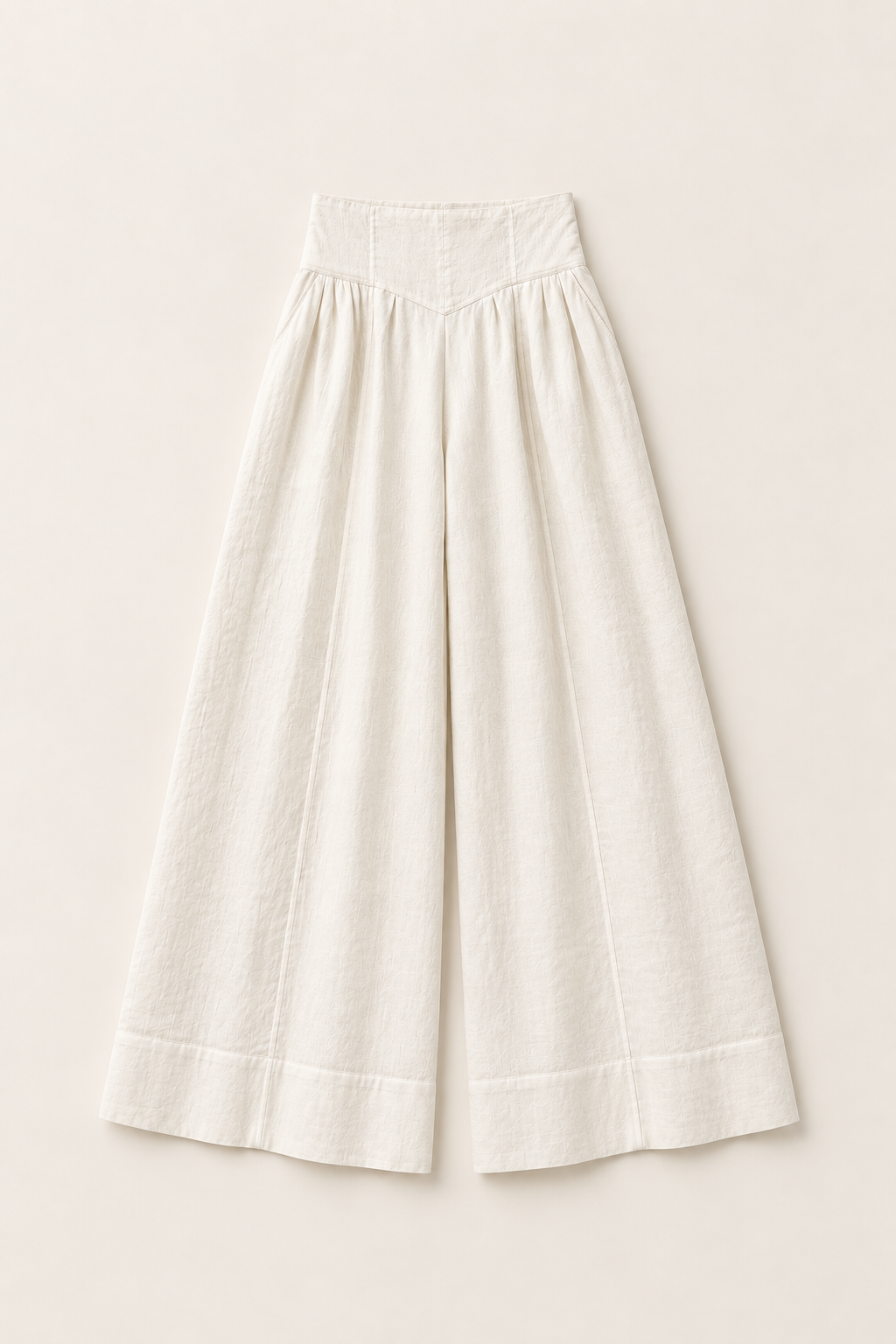 A pair of off-white linen wide-leg cropped pants with a gathered waist and double hem, displayed flat against a light beige background.