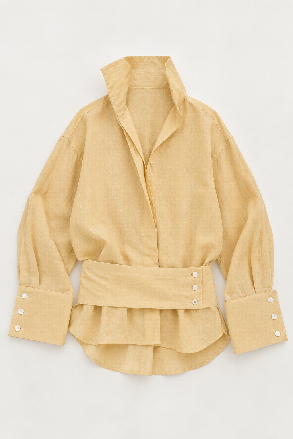 A light yellow linen shirt with a high collar, button-down front, and a matching fabric waist belt with decorative buttons, laid flat on a white background.
