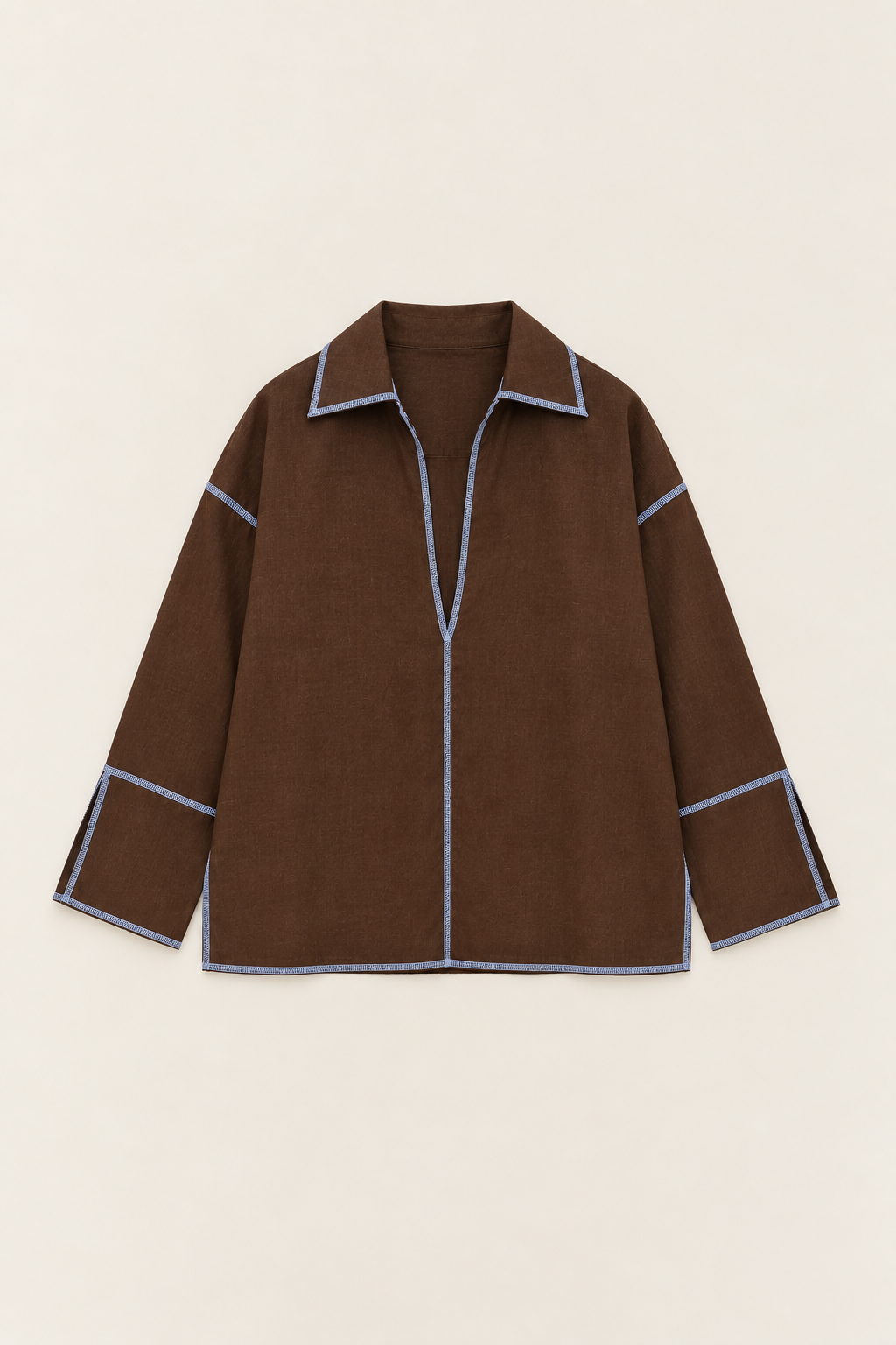 A brown long-sleeve shirt jacket with light blue contrast stitching along the collar, front placket, cuffs, and hem, displayed flat against a light beige background.