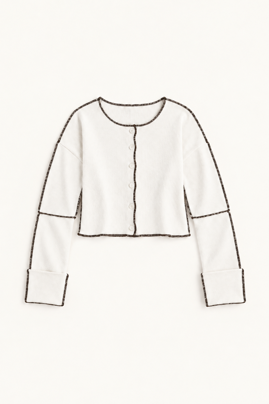 An off-white cropped cardigan with long sleeves and contrasting dark brown outline stitching, shown flat against a solid off-white background.